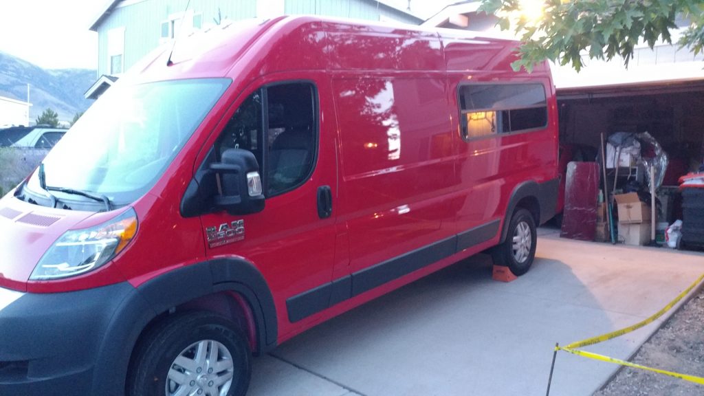 The Ram ProMaster van conversion is currently stationary in a parked position.
